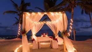 A heart-shaped outdoor dining setup with string lights, surrounded by palm trees and a beach view. - 1BR Seaside Casita @ Sapphire Beach Resort (San Pedro Town)