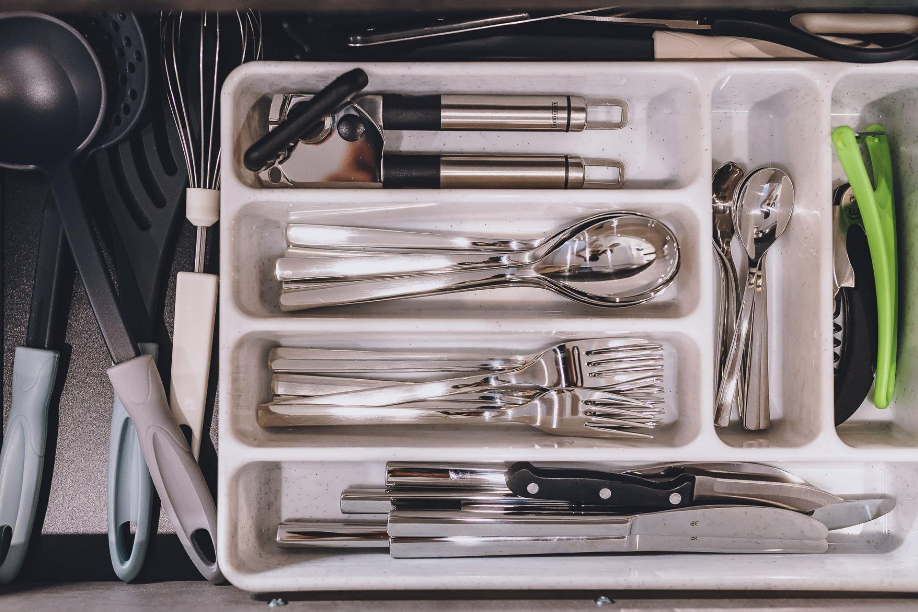 A kitchen utensil organizer with compartments for various tools.
