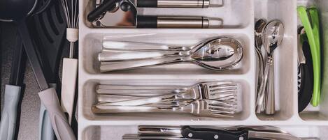 A kitchen utensil organizer with compartments for various tools.