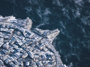 An aerial view of a coastal city with dense urban development, a prominent waterfront, and a large domed building. - Chalet Molly in Zell am See (Zell am See)