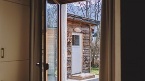 A wooden cabin with a door and a small porch. - Chalet Molly in Zell am See (Zell am See)