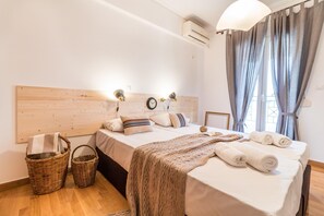 Relax in this inviting hotel room with a comfortable bed, wicker baskets, and a stylish headboard.