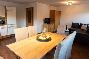 Cozy living space with a dining table, kitchenette, and comfortable seating area.