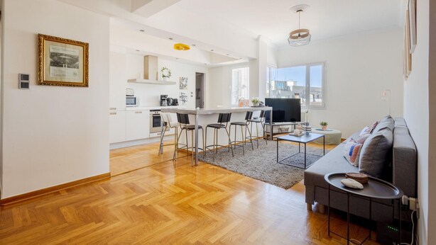 A modern living space with a kitchen, dining area, and seating area. - 3 Bdrm Luxury Apt Incredible Acropolis View (Athens)