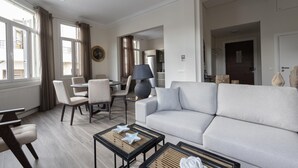 A modern living room with a sofa, chairs, a coffee table, and a lamp. - Plaka s Privileged Accommodation (Athens)