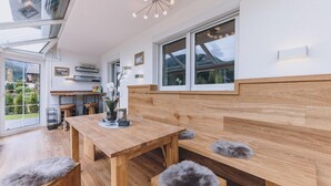 A modern kitchen with wooden countertops, a built-in oven, and a large window. - Spa Chalet - Garden Lodge (Zell am See)
