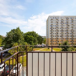 Stunning high-rise building surrounded by lush greenery and a well-manicured lawn.