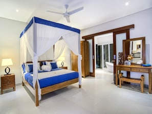 Relax in a serene space with a spacious bed, a comfortable nightstand, and a stylish bench.