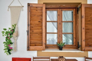 Relax in this serene space with a large window, potted plant, and inviting atmosphere.