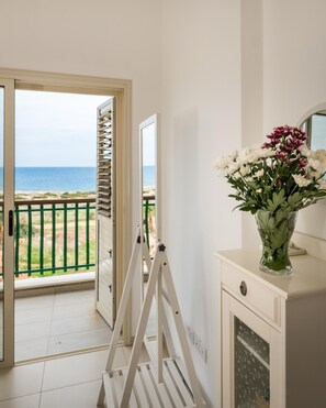 Enjoy stunning ocean views from the balcony, featuring a comfortable seating area and a beautiful beach view.