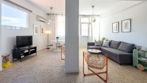 A modern living room with a television, sofa, and coffee table. - Loft at Historical Center of Athens w Acropolis View (Athens)