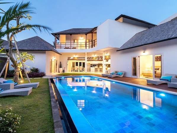 Enjoy a relaxing outdoor space with a spacious pool, patio, and comfortable seating.