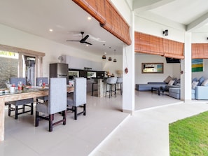 Relax in this open-plan living space with a kitchen, dining area, and cozy seating nook.