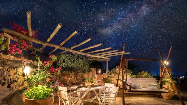 An outdoor patio with a pergola, seating area, and potted plants under a starry night sky. - Luxury Villa Golden Crest With Private Swimming Pool (Hersonissos)