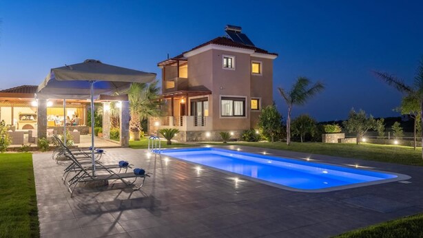 A modern two-story house with a swimming pool, outdoor seating, and a covered patio area. - Villa David With Private Pool (Malevizi)