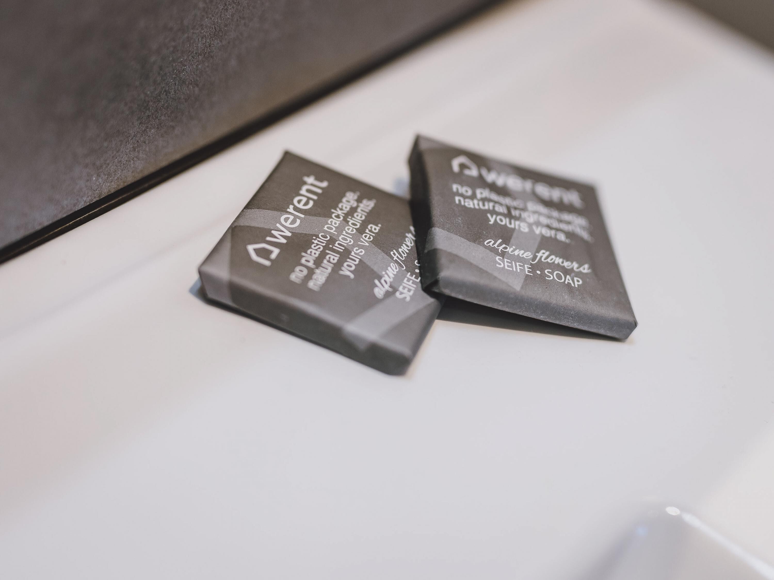 Two soap bars with text on them.