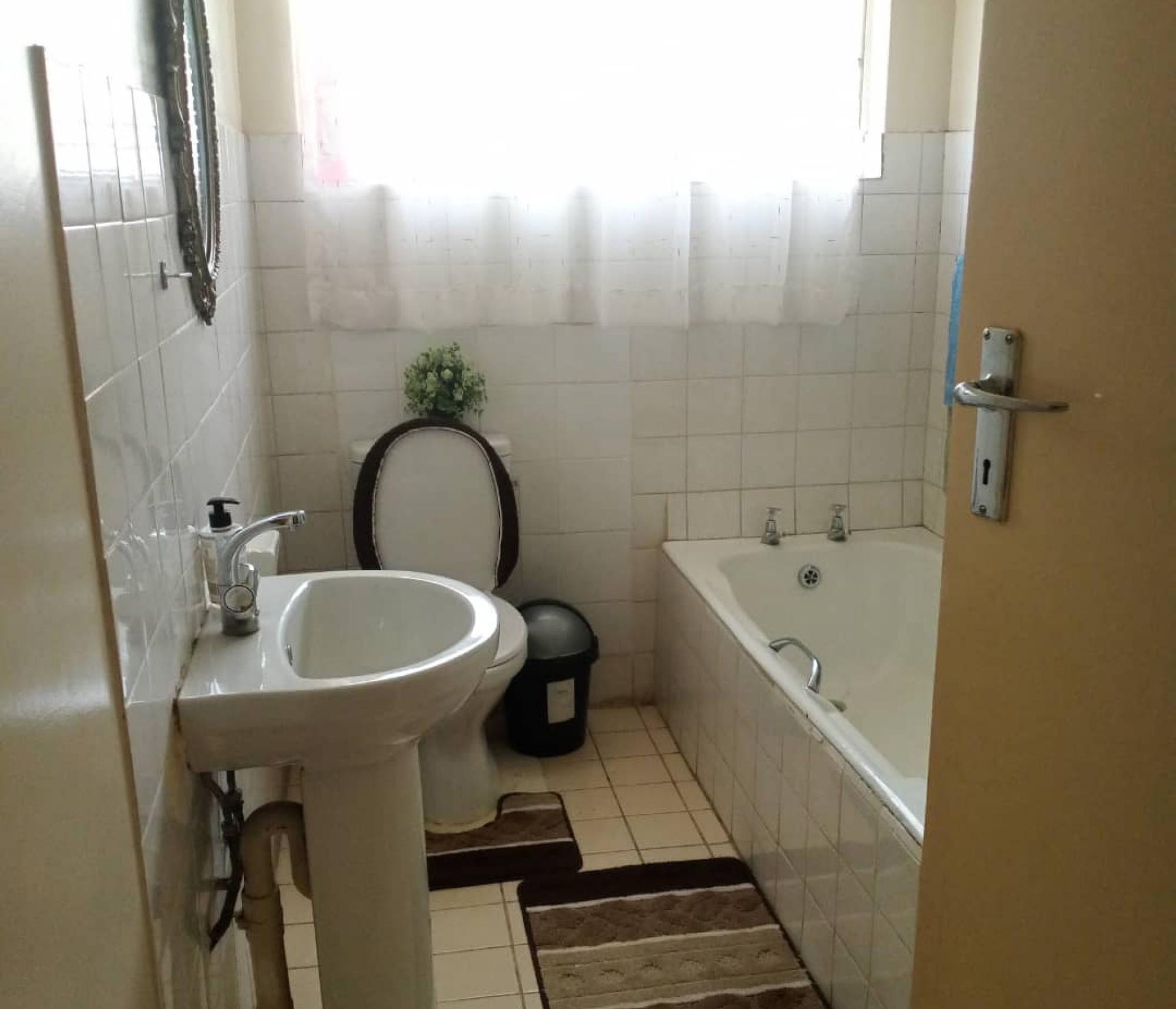 A bathroom with a sink, toilet, and bathtub.