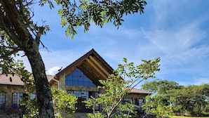 A large stone building with a prominent triangular roof and a glass facade.