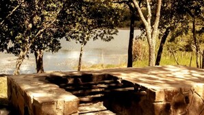 A stone staircase leading to a viewing platform by a lake, surrounded by trees.