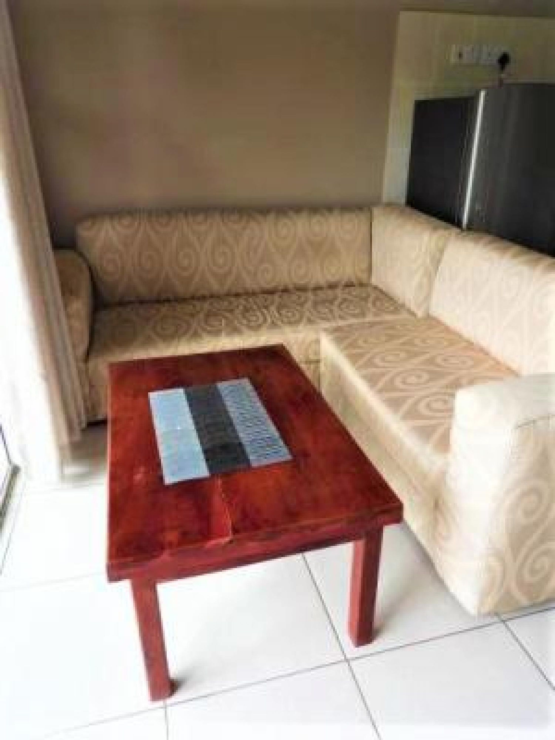 A living room with a sofa and a wooden coffee table.
