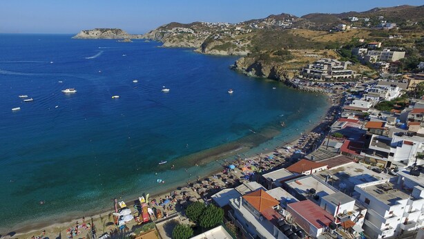 An aerial view of a coastal town with a beach, boats, and buildings. - Apartments for 3 1st Floor (Malevizi)