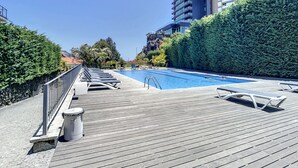 Un espace aménagé au bord de la piscine, avec des chaises longues et une piscine à l’eau d’un bleu limpide.
