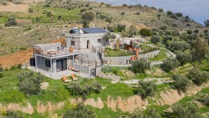 A stone villa with a terrace, solar panels, and a pool. - Elena Junior Deluxe Suite by Estia (Agios Vasileios)