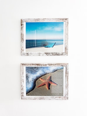 Two framed pictures: one of a beach with a hammock and the other of a starfish on sand. - Residences C14-1d in Chame (Punta Chame)
