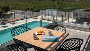 A poolside table with a book, two mugs, and a plate of pastries. - Luxurious Villa Micha Mare - 14 Bedrooms (Mylopotamos)