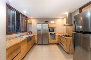 Enjoy cooking in this well-equipped kitchen with a refrigerator, oven, microwave, sink, and stovetop.