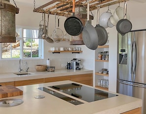 Enjoy cooking in this well-lit kitchen with a central island and stovetop.