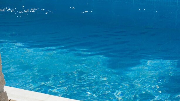 A wooden deck with a pool and two white lanterns. - Villa Prima - With Private Heated Pool (Rethymno)