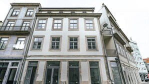 A multi-story building with a classical architectural style, featuring large windows and a balcony on the upper floors. - Nomad s Formosa Comfort - 1bed Porto (Porto)