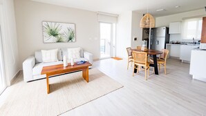 A modern apartment with a living room, dining area, and kitchen. - Residences C4-1c in Chame (Punta Chame)