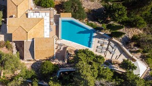 An aerial view of a property with a swimming pool, wooden deck, and stone architecture. - Danai Villa - Charming Escape With Oceanside Views (Paxos)