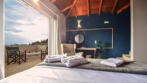 A bedroom with a large bed, a wooden ceiling, a view of the sky, a round mirror, and a desk with a plant. - Danai Villa - Charming Escape With Oceanside Views (Paxos)