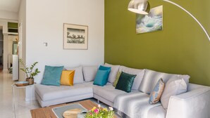 A modern living room with a sectional sofa, a coffee table, and a floor lamp.