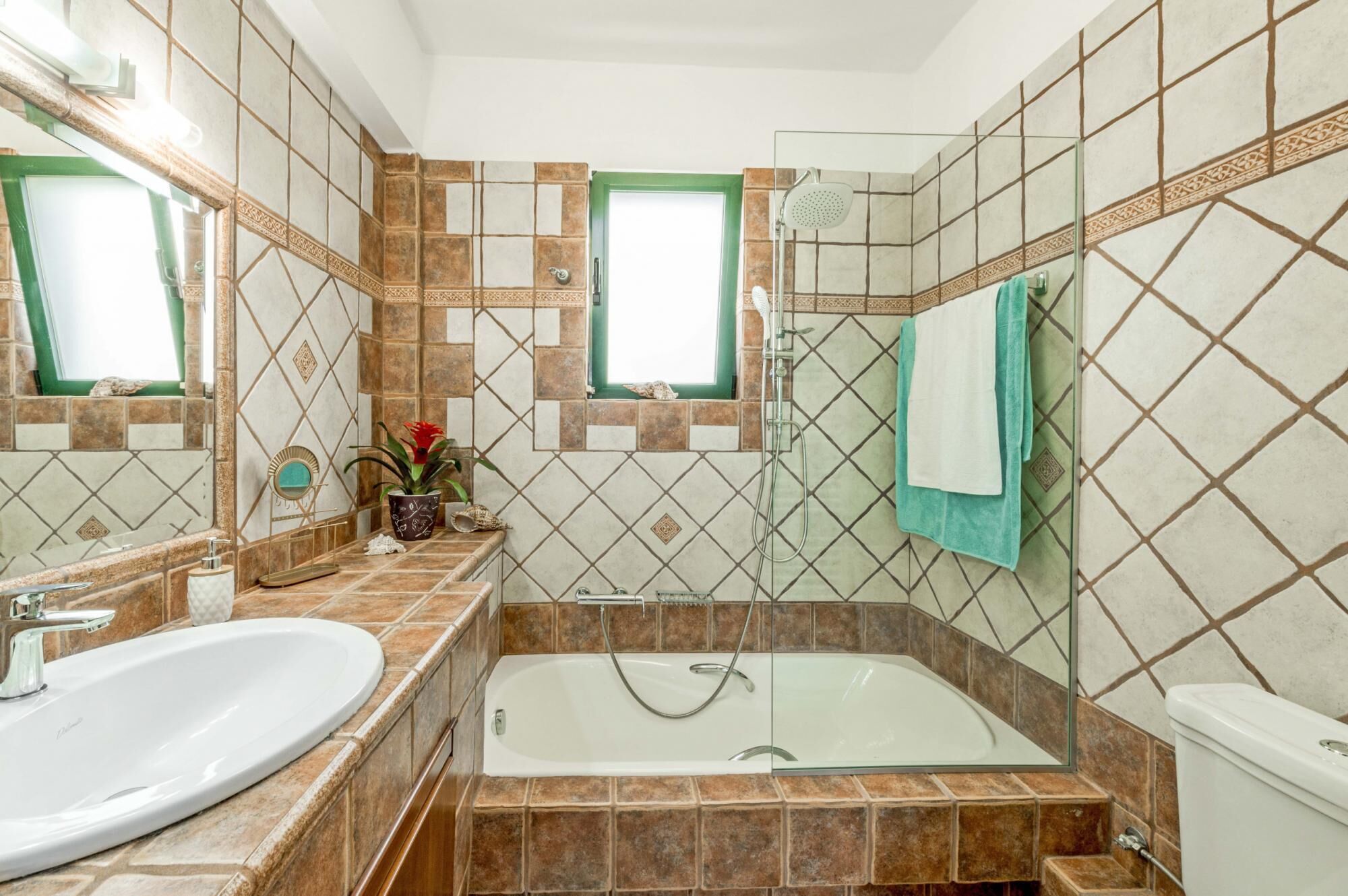 A bathroom with a large bathtub, a separate sink, and a shower area.