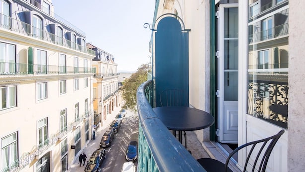 A balcony with a view of a street lined with parked cars and buildings. - Nomad s Chiado Lisbon - The Ivens Signature (Lisbon)