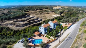 A large villa with a swimming pool, surrounded by terraced fields and a road. - Blue Villa 1 - With Private Pool (Mylopotamos)