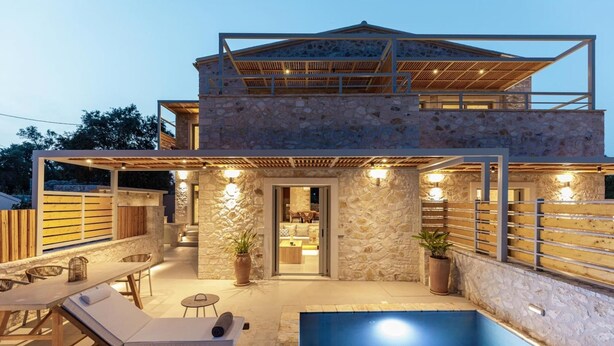 A modern stone house with a pool, outdoor seating, and a covered patio area. - Armonia II Villa in Paxi (Paxos)