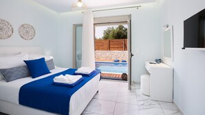 A modern bedroom with a bed, a small bedside table, a mirror, and a view of a swimming pool. - Villa Vera - With Private Pool Jacuzzi (Rethymno)