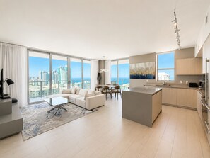 A modern apartment with a living area, dining space, and kitchen, featuring large windows and a city view. - ★★★★★MILLION APART 2BD. 1MIN TO BEACH - no resort & parking fee, check details (Hollywood)