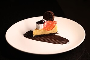 A dessert on a white plate with a dark background. - Fairfield by Marriott Agra (Agra)