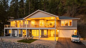 A two-story house with a covered patio, a garage, and a driveway. - Okanagan Lakeview Oasis, 2 Bed, 2 Bath, Sleeps 6 (Vernon)