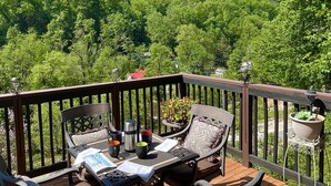 Une terrasse dotée de mobilier d’extérieur et offrant une vue sur un paysage montagneux.