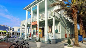 A building with a balcony, a sign reading "Central Square," and a palm tree. - AZUL | Beachfront Unit | Panoramic Gulf Views (Santa Rosa Beach)