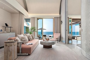 A modern hotel room with a large sofa, a coffee table, and a view of the ocean. - JOALI BEING (Bodufushi)