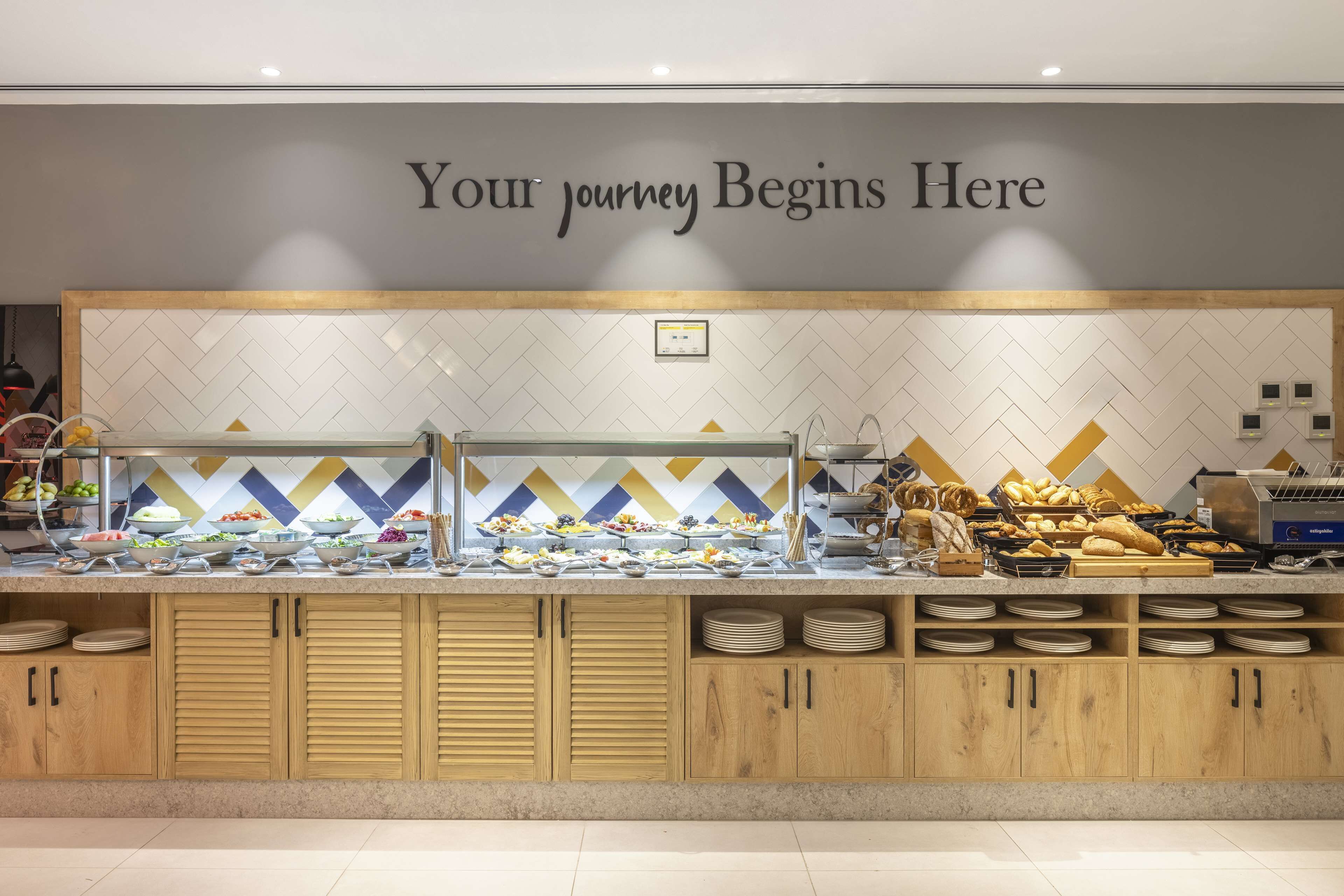 A buffet area with a sign that reads "Your journey Begins Here."