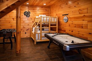 A cozy room with a foosball table, a shuffleboard table, and a bunk bed. - Private Mountain Escape for Large Groups Sleeps 17 (Dobson)